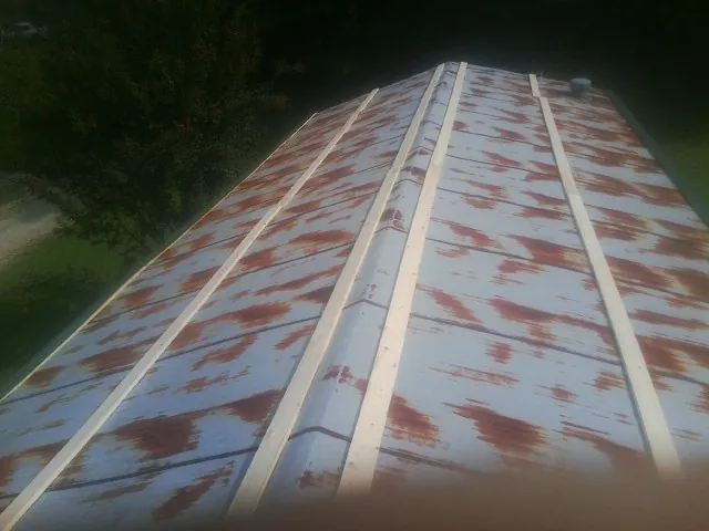 Rusted metal roof panels with new wood purlins before replacement — Storm Damage Roof Repair in Conyngham by Roofing Brothers